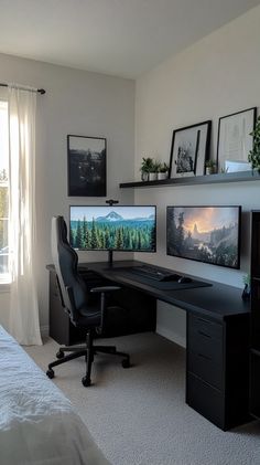 there is a desk with two monitors and a keyboard on the desk in this room