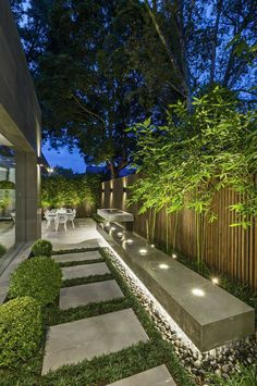 a modern garden with stepping stones and lights