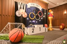 an indoor basketball court with various sports equipment and decorations on the floor, including a goalie's net