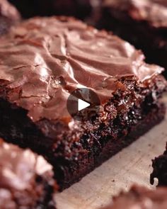 brownies with chocolate frosting sitting on a cutting board