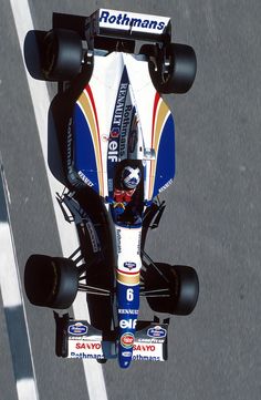 a man driving a race car on top of a track