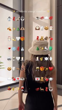 a woman in a black dress and hat walking down a hallway with lots of buttons on the wall