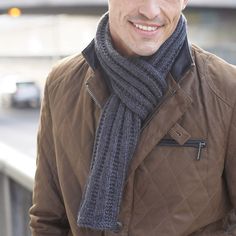 a man wearing a brown jacket and scarf