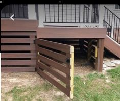 a dog house built into the side of a building with stairs leading up to it