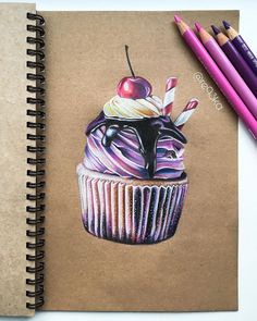 a drawing of a cupcake with cherries and chocolate on top, next to colored pencils