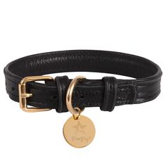 a black leather bracelet with a gold plated charm on the clasp and a star