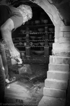 a man is working in an old brick oven