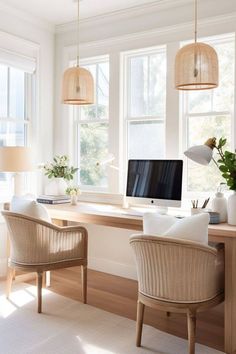 a home office with wicker chairs and a computer on a desk in front of two windows