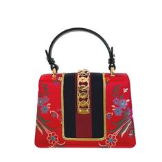 Red brocade Sylvie bag is crafted to a compact, structured shape with black leather trims, and detailed with all the house hallmarks: navy and red Web stripe, gold-tone metal chain, and logo-engraved buckle-effect clasp. One leather top handle Floral patternBlue and red web detailGold-tone hardwareMetal chain with buckle fasteningInternal open pocketSuede liningColor: RedComposition: silk, leather, suede, metalMeasurements: base L 8"/20cm, W 3.25"/8cm, H 5.65"/14cmMade in Italy Web Detail, Red Web, Red Purse, Perfect Bag, Handle Bag, Black Handbags, Bag Tags, Leather Top, Gold Tone Metal