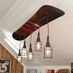 a bunch of lights hanging from the ceiling in a room with wood paneling and white walls