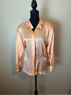 ESCADA Cream Orange 100% Silk French Cuff Blouse Shirt  Size 34, fits like a small or medium, see measurements Good condition, very minor wear This early-1990s Escada by Margaretha Ley collared blouse is made of 100% silk.  Cuffs each have 2 buttons easily removable shoulder pads Darting in the back  Long sleeve button up  Pit to pit 21" Length shoulder to hem 27" D100 Vintage Formal Tops With Spread Collar, Spring Silk Tops With Cuffed Sleeves, Fitted Silk Tops With Cuffed Sleeves, Vintage Silk Tops For Workwear, Semi-stitched Art Silk Blouse In Orange, Orange Semi-stitched Silk Blouse Piece, Vintage Button-up Cream Blouse, Vintage Orange Long Sleeve Blouse, Vintage Silk Collared Top