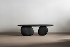 a black table sitting on top of a wooden floor