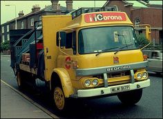 a yellow truck is parked on the side of the road