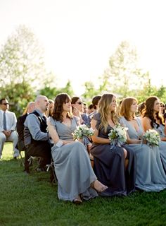 a group of people that are sitting in the grass