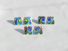 The advantages of the cloisonne enamel earrings: 🔷 it is lightweight 🔷 100 % handmade 🔷 is unique, one of a kind 🔷 reasonable size and weight allows you to wear every day 🔷 matches with different types of outfits - dresses and pants as well 🔷 May be a perfect gift for people who love handmade gifts ... This artwork earrings are 100 % handmade by me in my studio. The technique is called Cloisonne enamel which is well known in Georgia. Cloissone is using tiny metal strips to make a pattern then putting powder enamel into the spaces to make a design. Then it is heated in a kiln until the powder becomes glass. Cloisonne enamel is such a delicate art form... Many people in my country love buying handmade cloisonne enamel jewelry because they are unique and special!  DIMENSIONS: 0.5 X 0.5 Silver Enamel Pin For Gift, Artistic Enamel Jewelry For Formal Occasions, Green Enamel Earrings With Artistic Design, Enamel Earrings With Artistic Design For Gift, Artistic Enamel Earrings With Artistic Design, Artistic Enamel Earrings For Gifts, Unique Enamel Earrings For Gift, Artistic Design Enamel Earrings, Unique Multicolor Enamel Pin Gift