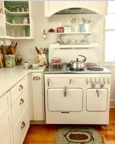 an old fashioned stove in a white kitchen