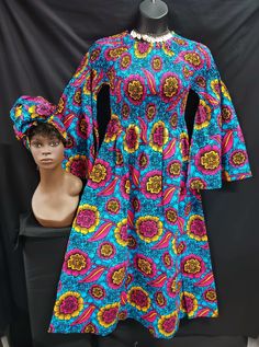 "Beautiful African print Dress with matching headwrap.  Colors dark pink, gold, blue ans black.  On/off shoulder Elastic Top to waist makes for nice fit for various sizes and figures. Long flare sleeves to wrist, ankle length with pockets. Perfect for all occasions. 100% cotton.  One size fits most (Medium to 2XL)  Measurements: Elastic top Bust 28\" - 48\" Sleeves length shoulder to waist 28\"- 44\" Hips- 54\" Length waist to hem 37\"" Fitted Long Sleeve Ankara Maxi Dress, Blue Long Sleeve Ankara Dress, Long Sleeve Ankara Fabric Spring Dress, Spring Ankara Long Sleeve Dress, Spring Long Sleeve Ankara Dress, High Wasted Pants, Elastic Top, Flare Sleeves, African Print Dress