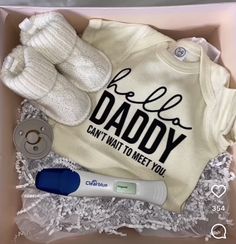 a baby gift box with an infant's bodysuit, booties and pacifier