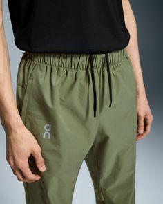 Lightweight and stretchy, these pants are dedicated to enhancing the joy of running. Made to move with you. Any direction. Any rhythm. The Core Pants move with you, thanks to an elastic waistband, gusset insert and pre-shaped knee construction. Plus, a hem that zips up to the knee makes changing into your gear a breeze. Engineered for 100% focus. No distractions. Just the run. A drawcord at the waist ensures a secure fit. And two side pockets mean you can keep essentials to hand. The lightweight Green Athleisure Bottoms For Outdoor, Stretch Tapered Leg Outdoor Pants, Green Athleisure Pants With Elastic Side Panels, Functional Stretch Pants With Ribbed Waistband, Functional Green Bottoms With Elastic Waistband, Outdoor Sportswear Sweatpants With Elastic Waistband, Versatile Jogging Pants With Ribbed Waistband, Outdoor Pants With Elastic Waistband And 4-way Stretch, Green Relaxed Fit Functional Bottoms