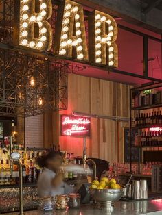 a bar with neon signs and lights above it