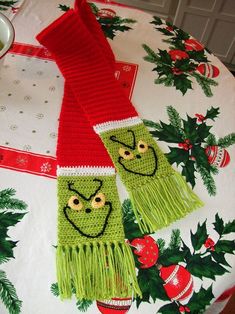 two scarfs on top of a table covered in christmas decorations