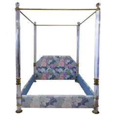 a bed frame with flowers on it and metal posts in the middle, against a white background