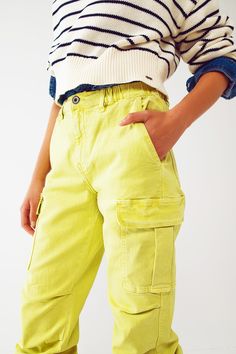 Introducing our Cargo Pants with Tassel Ends in Lime, a stylish and comfortable choice for a casual yet fashionable look. These ankle-length pants are designed to provide a relaxed and effortless fit. With a relaxed fit and straight leg, these cargo pants offer a laid-back style that is perfect for everyday wear. The comfortable fit allows for easy movement, while the straight leg design adds a touch of versatility. Crafted from stretch denim, these pants provide a comfortable and flexible feel. Stretch Denim Fabric, Denim Pocket, Effortless Outfit, Casual Belt, Modern Trend, Fuchsia Color, Perfect Wardrobe, Laid Back Style, Denim Fabric