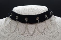 This gothy, punky choker is made from cotton ribbon set with eyelets running along the middle. The silver plated chain hangs in loops from rings attached through the eyelets and sits elegantly on the collar line.  The choker can be adjusted in length using the extender chain.   Allergy Information  I take customer care very seriously and make sure that all my jewellery is Nickel free.  * All items come in gift-wrapped jewellery box free of charge * Gothic Metal Choker For Concerts, Emo Metal Choker For Festivals, Emo Style Metal Choker For Festivals, Silver Grunge Choker For Concert, Metal Emo Choker For Alternative Fashion, Silver Emo Choker For Concert, Alternative Style Silver Choker For Concert, Gothic Chain Choker For Concerts, Silver Emo Choker For Alternative Fashion