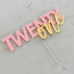 a cake topper that says twenty one on it with the word twenty in gold and pink