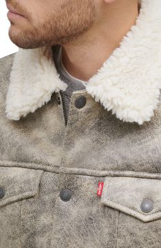 Be cozy, warm and classically cool in this trucker jacket featuring a solid wash and plush faux-shearling lining. 25 1/2" length (size Medium) Front snap closure Spread collar Button cuffs Chest button-flap patch pockets; front welt pockets Lined, with synthetic fill 99% polyester, 1% spandex with 100% polyester faux-shearling trim Machine wash, tumble dry Imported Men's Clothing Casual Shearling Outerwear With Faux Fur Lining, Casual Shearling Outerwear With Padded Collar, Levis Shirt, Levis Jacket, Trucker Jacket, Shearling Jacket, Gray Jacket, Welt Pockets, Welt Pocket