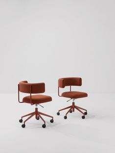 two office chairs with wheels on each side and an orange upholstered chair in the middle