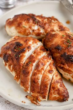 two pieces of chicken on a white plate