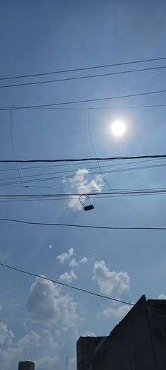 the sun shines brightly through power lines