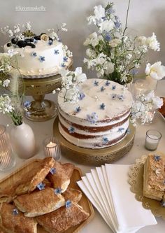 a table topped with cakes and desserts covered in frosting