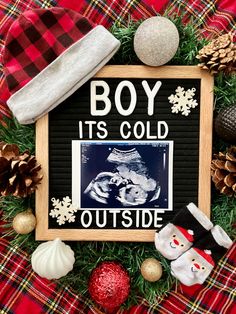 a christmas wreath with an image of a boy in the middle and other holiday decorations around it