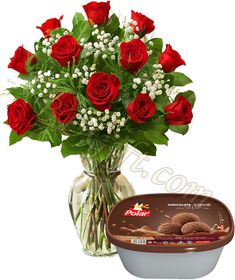 a vase filled with red roses next to a container of chocolate