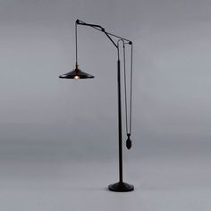 a black floor lamp with two lights on each side and one light on the other