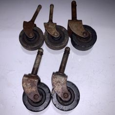 four cast iron castes with wheels on top of each one and two are missing