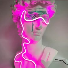 a pink neon sign with a woman's head wearing glasses