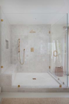 a walk in shower sitting next to a bath tub