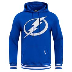 The Men's Pro Standard Blue Tampa Bay Lightning Retro Classic Fleece Pullover Hoodie is a must-have for any true Tampa Bay Lightning fan. With its embroidered fabric applique featuring chenille details and raised accents, this hoodie is sure to turn heads. The soft fleece lining ensures warmth and comfort, while the front pouch pocket provides convenient storage for essentials. Whether cheering on the Lightning at the game or relaxing at home, this hoodie is the perfect way to showcase your unwa Winter Team Logo Hoodie Sweatshirt, Winter Sweatshirt With Team Logo And Hood, Winter Crew Neck Hoodie With Team Logo, Winter Hooded Sweatshirt With Team Logo, Fleece Hoodie With Ribbed Cuffs For Fans, Athleisure Hoodie For Fan Gear, Winter Team Logo Hoodie With Crew Neck, Winter Streetwear Sweatshirt With Team Logo, Hooded Sweatshirt With Team Logo For Sports Season