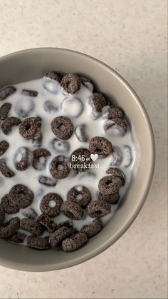 a bowl filled with cereal and milk on top of a table