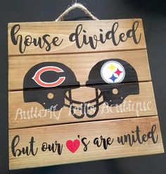 a wooden sign with two football helmets on it