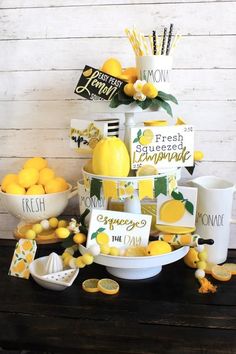 a table topped with lemons and cups