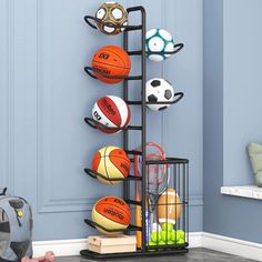 a rack with basketballs, balls and other sports equipment on it in a child's room