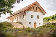 a white house sitting on top of a lush green hillside