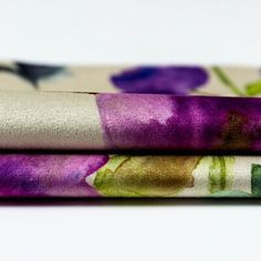 three different types of fabric with flowers on them, one in purple and the other in green