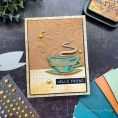 a close up of a card on a table with other cards and paper items around it