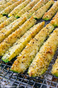 grilled zucchini on a grill with seasoning sprinkles and parmesan cheese