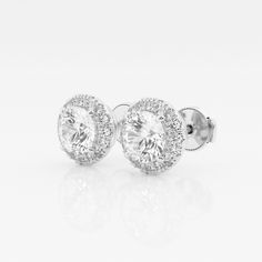 Enhance your everyday studs with these halo diamond stud earings. Each large round lab grown diamond is encircled with enchanting smaller diamonds to create a halo effect. White Gold Round Cluster Earrings With Halo, White Round Halo Cluster Earrings, White Round Cluster Earrings With Halo, Diamond White Halo Setting Lab Grown Diamond Earrings, Classic Halo Cluster Earrings In Diamond White, Classic Diamond White Cluster Earrings With Halo, Diamond White Halo Setting Lab-grown Diamond Earrings, Classic Round Diamond Earrings With Halo, Diamond White Oval Halo Diamond Earrings